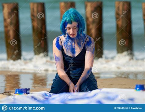 Artistic Blue Haired Woman Performance Artist In Dress Smeared With Blue Gouache Paints On Her