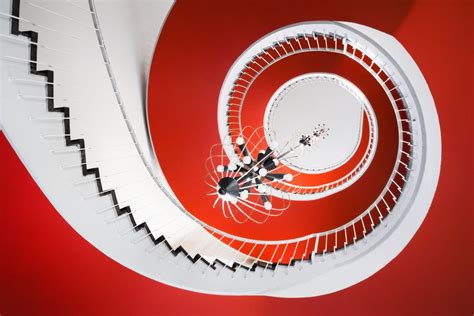 It is possible to go both up and down the spiral staircase and what lies at the bottom is different for every person. Red swirl by Matthias Haker / 500px | Spiral staircase, Beautiful stairs, Spiral stairs