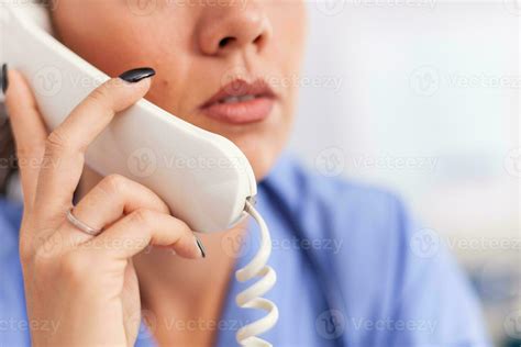 Medical Receptionist Answering Phone Calls From Patient In Hospital
