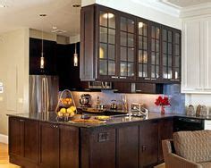 If you have less kitchen space to work with, consider a narrower kitchen island that drawers and cabinets keep kitchen tools hidden and organized. Upper Ceiling Mounted See Through Glass Cabinets Over ...