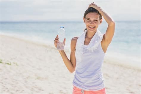 Happy Sporty Woman Holding A Bottle Of Mineral Water For Refresh Stock