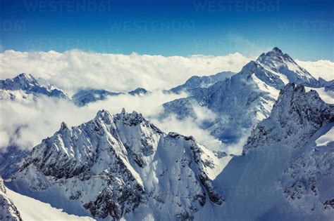Clouds On Snow Capped Mountain Peaks Engelberg Titlis Swiss Alps