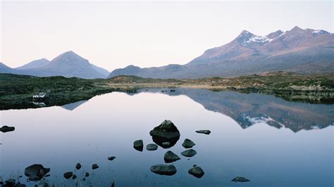 Cuillin Mountain Range Reflected In A Loch At Sunset Isle Of Skye
