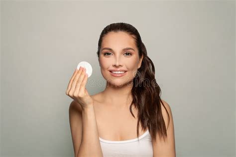 Young Brunette Woman Removing Makeup From Her Face Photo Of Beautiful