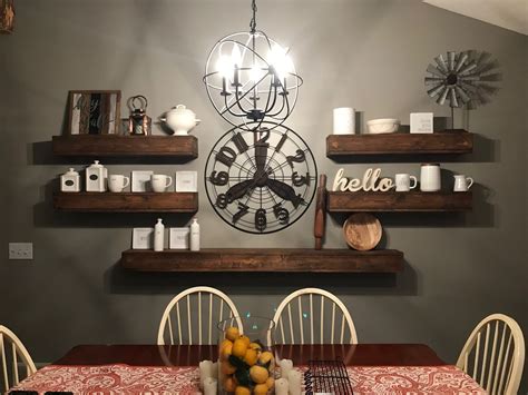 Hanging lots of photos in one place — and making them look nice — is hard. Floating wood shelves. Large clock decor | Kitchen decor ...