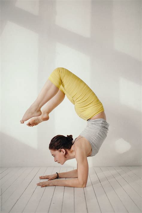 woman performing yoga handstand by stocksy contributor sergey filimonov stocksy