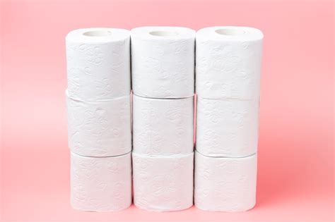 Premium Photo A Stack Of White Rolls In Toilet Paper On A Pink