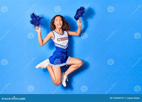 Young Beautiful Chinese Girl Smiling Happy Wearing Cheerleader Uniform