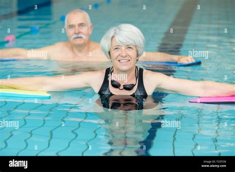 Senior Couple Relaxing In Swimming Pool Together Stock Photo Alamy