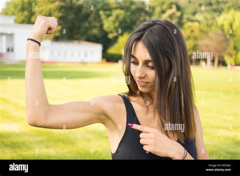 Fitness Girl Showing Her Well Trained Biceps After Working Out Outdoors