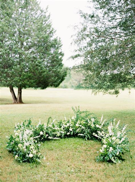 A Wedding Ceremony Trend Were Loving Grounded Floral Arches