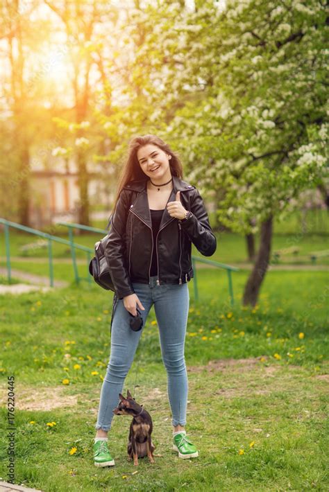 Young Beautiful Caucasian Girl Playing With Dog Russian Toy Terrier