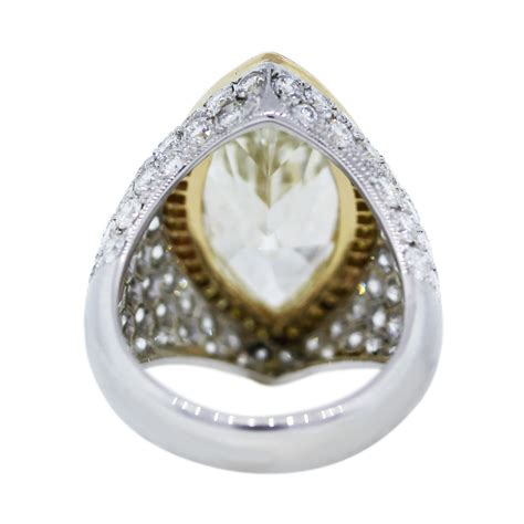 The marquise cut engagement ring is surging back into popularity as people look for less common engagement rings. Platinum & 18k Yellow Gold 7.22 Carat Marquise Cut Pave Set Engagement Ring