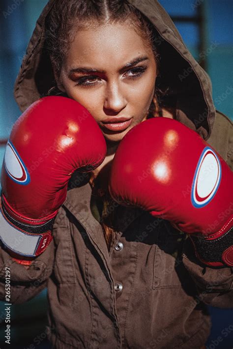 Portrait Of Female Boxer In Sport Wear With Fighting Stance Against Spotlight Sexy Fitness