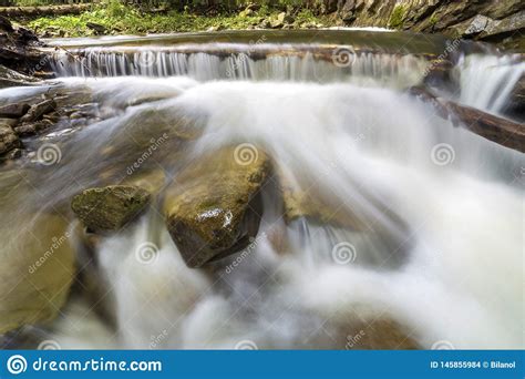 Fast Flowing River Stream With Smooth Silky Water Falling From Big