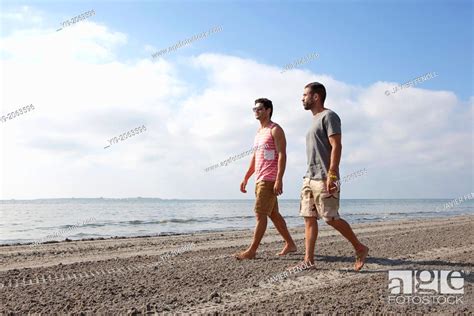 Two Men Walking On The Beach Stock Photo Picture And Rights Managed