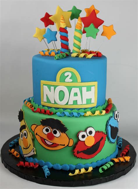 Yellow birthday cake with milk chocolate frosting is homemade and made from scratch with vanilla pudding and the perfect milk chocolate buttercream. Sesame Street Second Birthday Cake | Lil' Miss Cakes