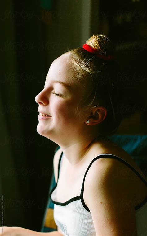 Smiling Preteen Girl With Eyes Closed By Stocksy Contributor Helen Rushbrook Stocksy
