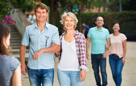 Couples Of Mature Males And Females Walking On Holiday Stock Image