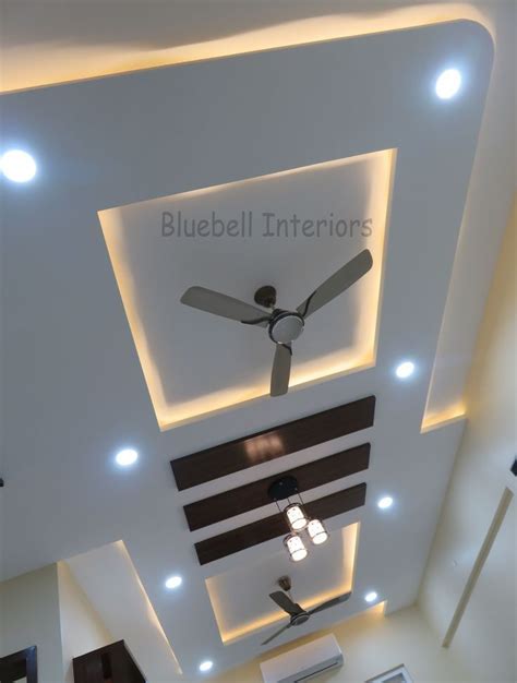 A Ceiling Fan Mounted To The Side Of A Wall In A Room With White Walls