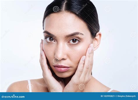 Beautiful Dark Haired Woman Cupping Her Face With Hands Stock Image