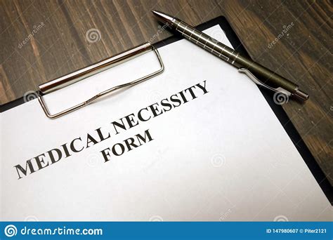 clipboard-with-medical-necessity-form-and-pen-on-desk-stock-image
