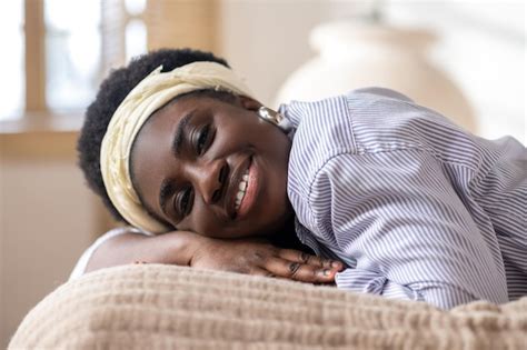 Premium Photo African American Woman Laying On Bed And Looking Dreamy