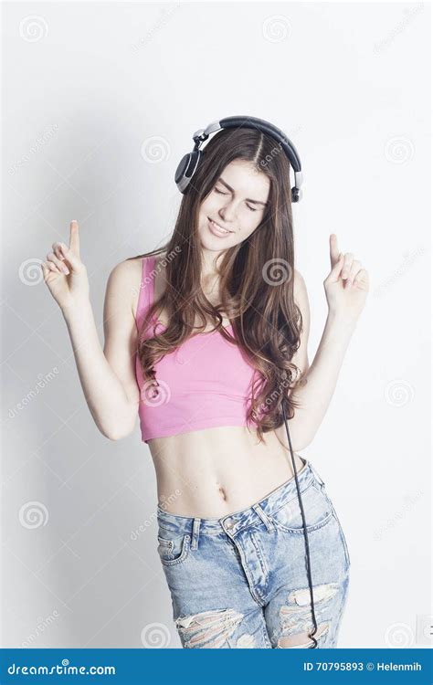 Young Girl Enjoying Music In Headphones With The Closed Eyes Stock