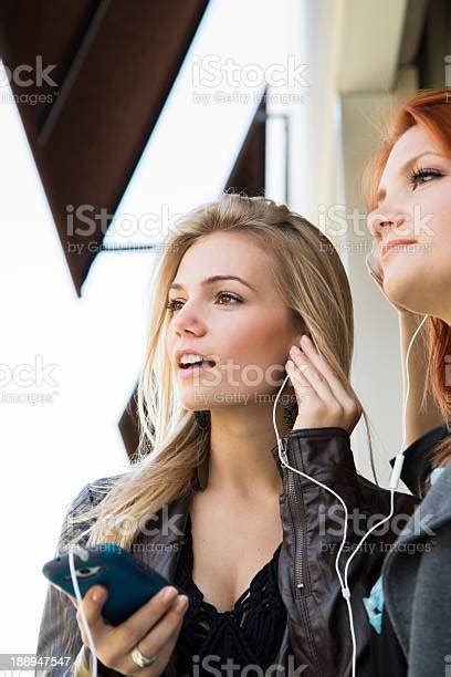 Two Friends Listening To Music Stock Photo Download Image Now 16 17