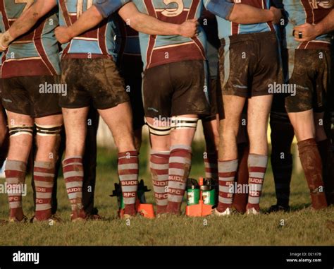 Muddy Rugby Players During A Half Time Huddle Bude Cornwall Uk Stock