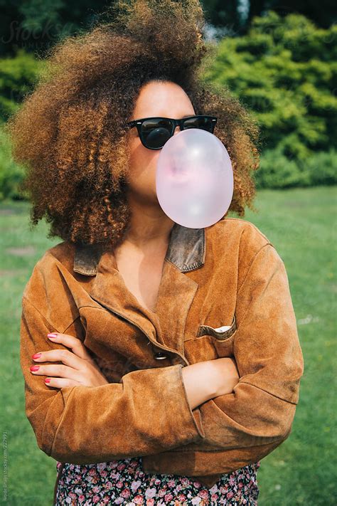 Girl With Big Afro Blowing A Bubble With Bubblegum By Stocksy Contributor Ivo De Bruijn