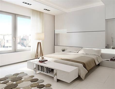 A Bedroom With White Walls And Flooring Has A Large Bed In Front Of The