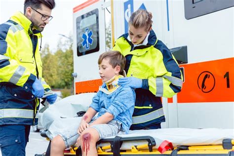 Emergency Medics Taking Care Of Injured Boy Stock Image Image Of