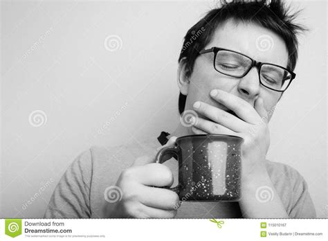 Sleepy Yawning Man In Eyeglasses With Red Cup Of Tea Or Coffee Has