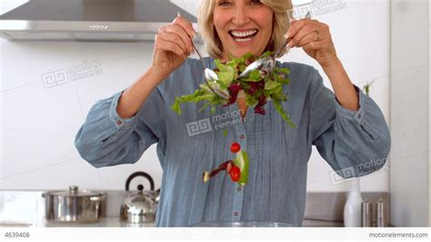 Smiling Woman Tossing Her Salad Stock Video Footage 4639408