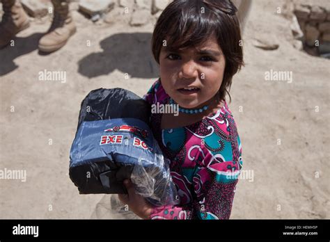 An Afghan Girl Carries A Winter Jacket That She Received From The Giro