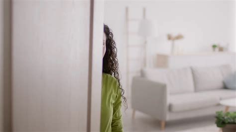 Woman Opening Door And Gesturing Inviting To Come In Indoor Stock Video