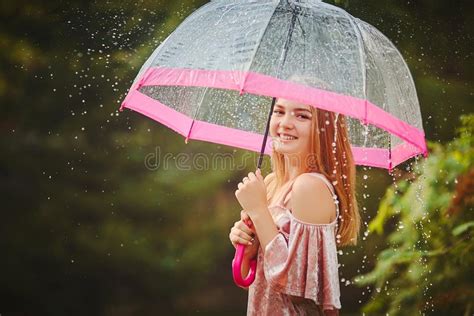 A Teenage Girl Hid From The Rain Under An Umbrella While Walking