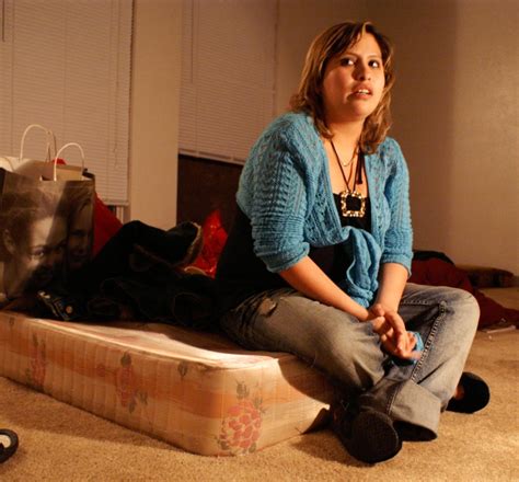 Woman Sitting On Bare Mattress With Legs Crossed The Portal To