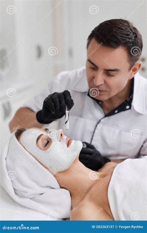 Beautician Applies The Mask To Face Of Woman In The Spa Salon Skin