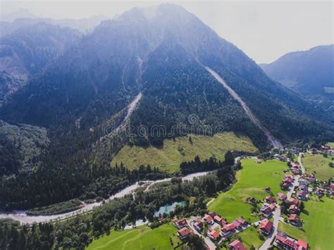 View Of Bavarian Alpine Village With A Valley And Mountains Shot From