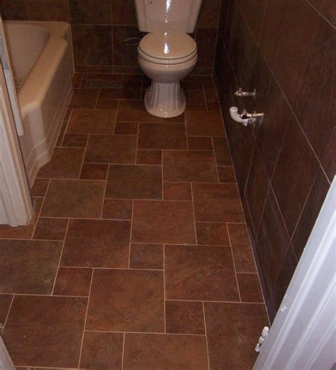 Grey tiled bathroom floor with white fixtures and white wall tile. A Safe Bathroom Floor Tile Ideas for Safe and Healthy ...