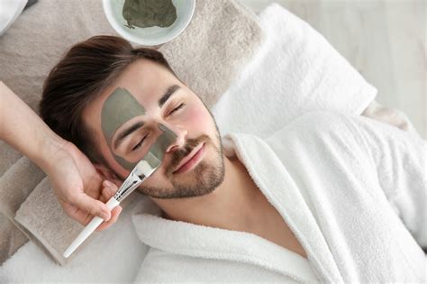 Cosmetologist Applying Mask On Clients Face In Spa Salon Above View