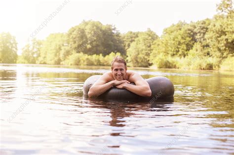 Man Floating In Inner Tube In Lake Stock Image F0150762 Science Photo Library