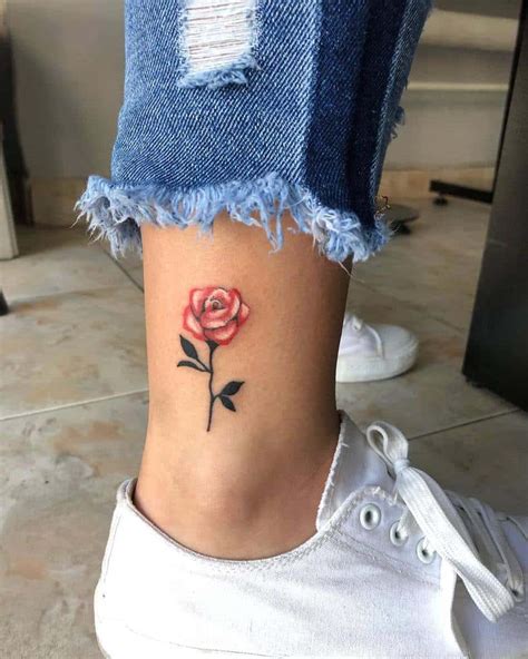 A tiny black rose tattoo in the middle of the right arm. Top 71 Best Small Rose Tattoo Ideas - 2021 Inspiration Guide