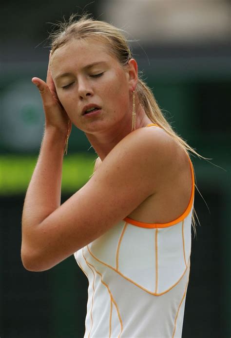 A Female Tennis Player Is Holding Her Hand To Her Head