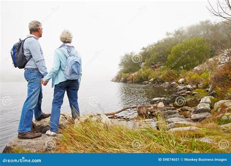 Senior Couple Standing By A Lake Stock Image Image Of Admiring Hiking 59874651