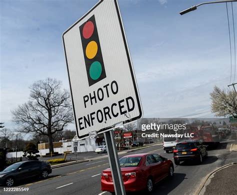 A Traffic Sign Reads Photo Enforced To Warn Of A Red Light Camera