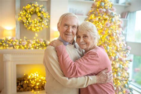 Senior Couple Hugging Each Other And Looking Happy Stock Image Image Of Love Togetherness
