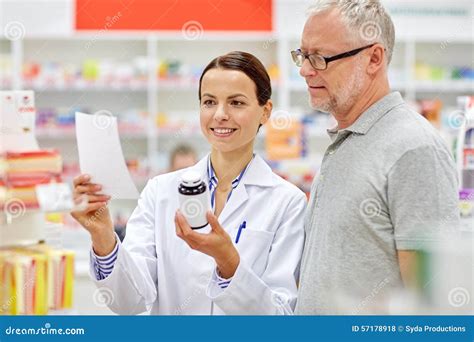 Pharmacist And Senior Man Buying Drug At Pharmacy Stock Photo - Image